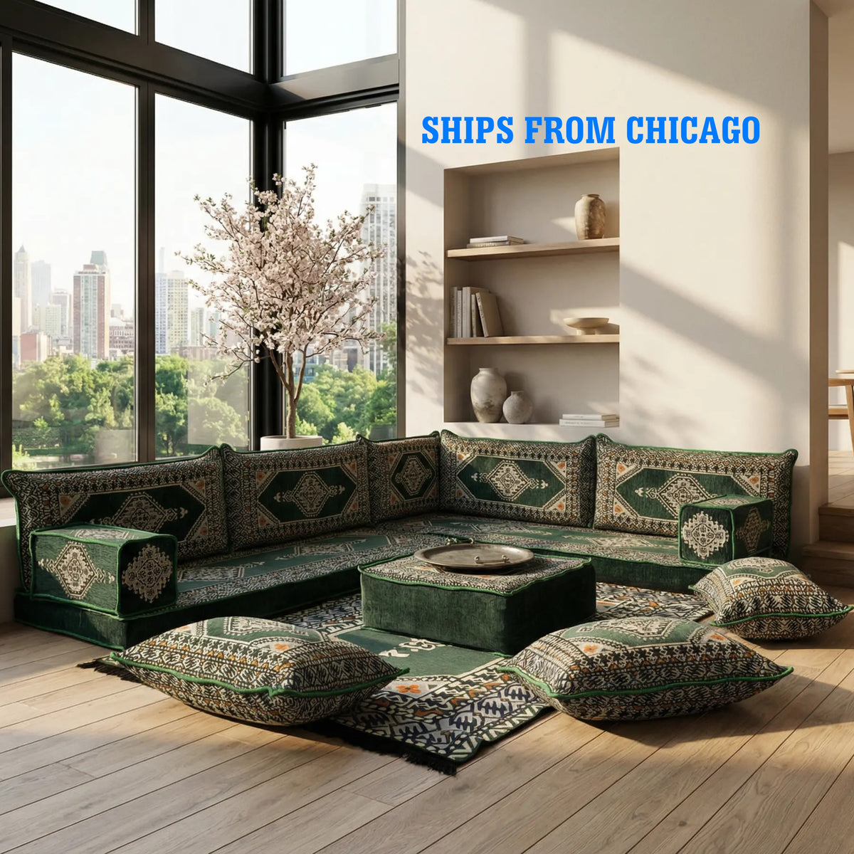 Green L-Shaped Sofa Set, Turkish Palace Floor Seating Sectional Modular Couch Set in a bright room with floor cushions and a matching ottoman, featuring green and beige patterned upholstery. Large windows show a city skyline, and blue text in the upper right reads 'SHIPS FROM CHICAGO'.