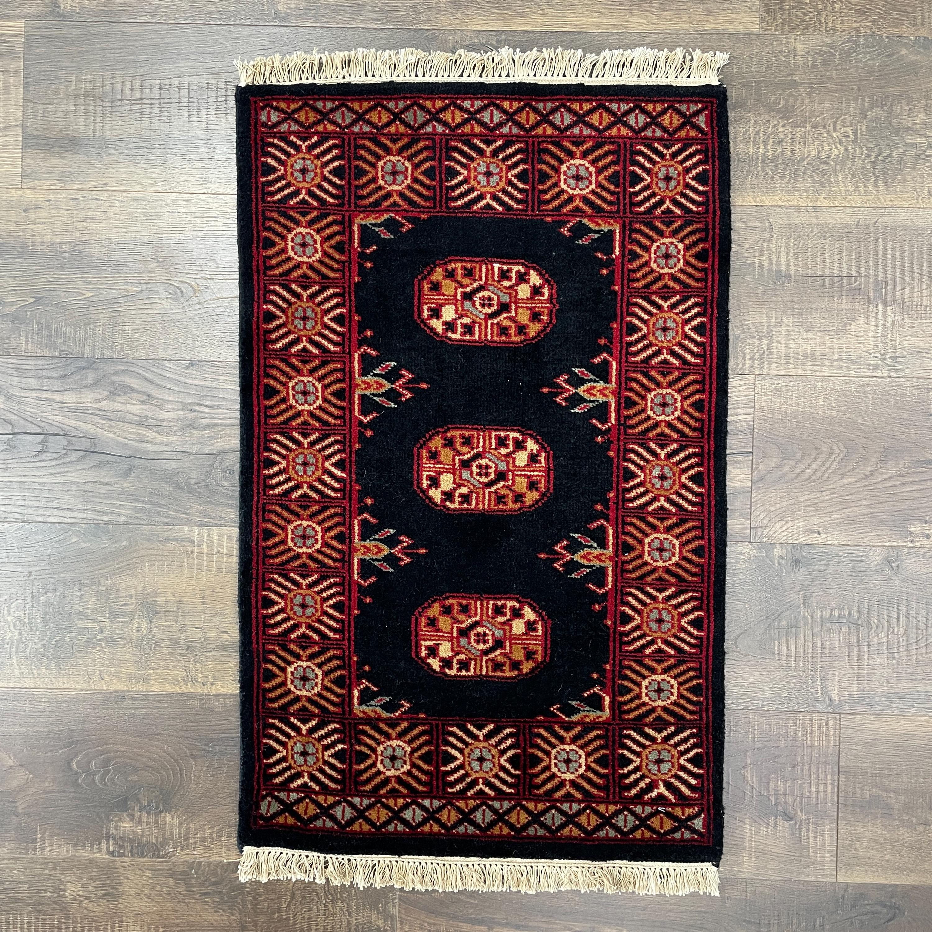 Handmade Turkish Wool Rug: Vintage Black Tribal Design (1'10" x 3')