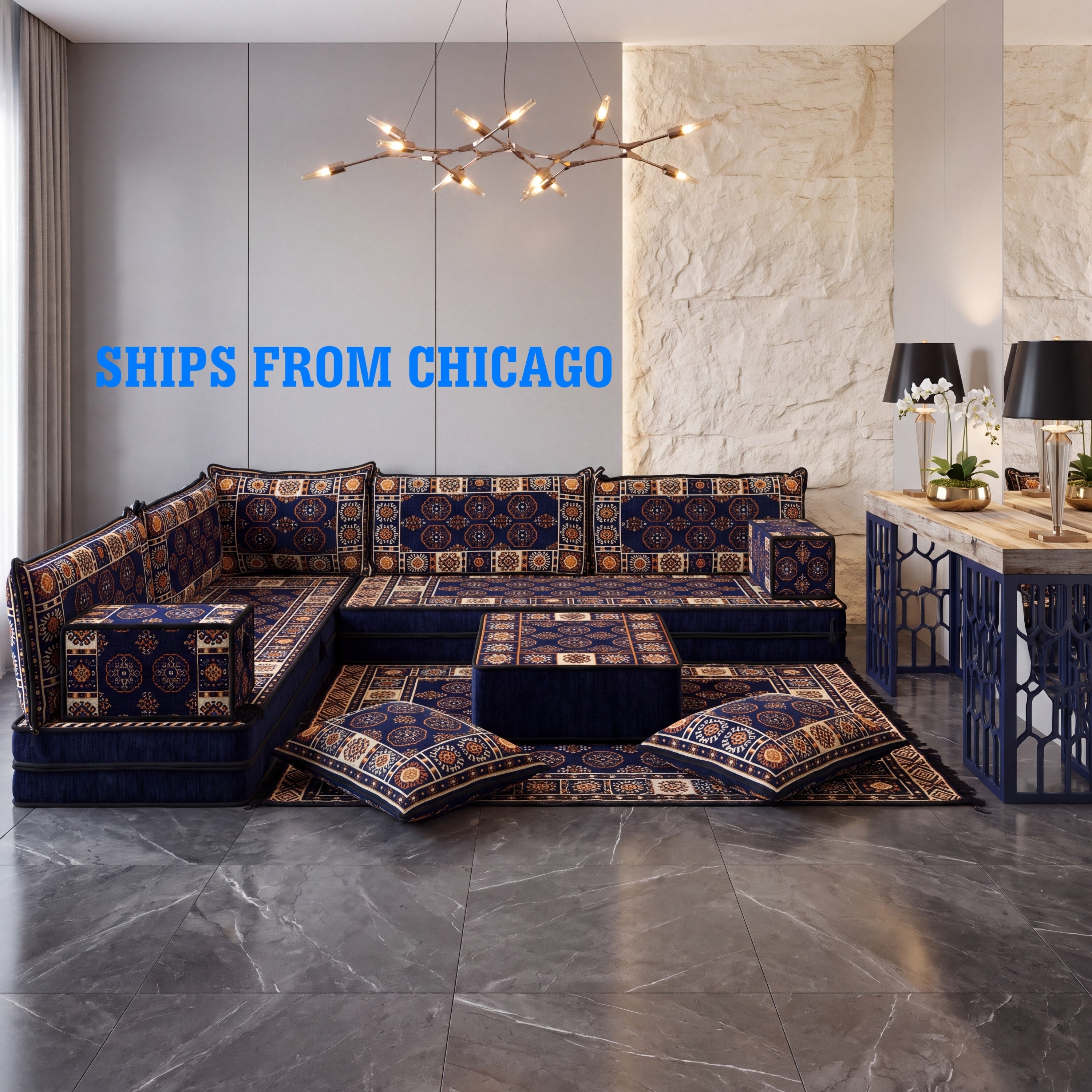 A large L-shaped navy blue sectional sofa with matching floor cushions and a ottoman and matching bukhara kilim rug. 