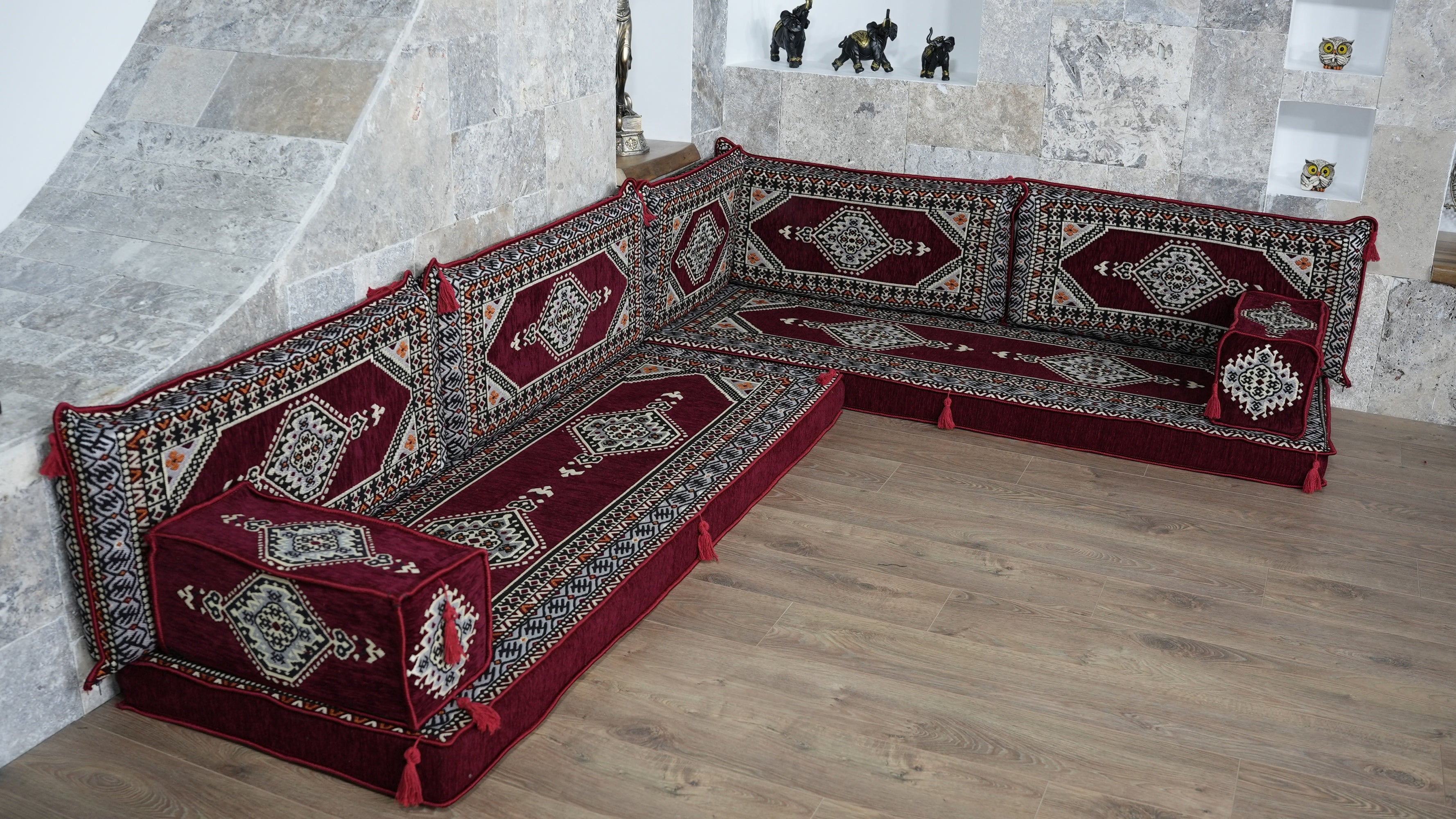 Decorative floor seating L-Shaped Sofa with intricate Arabic Majlis patterns.