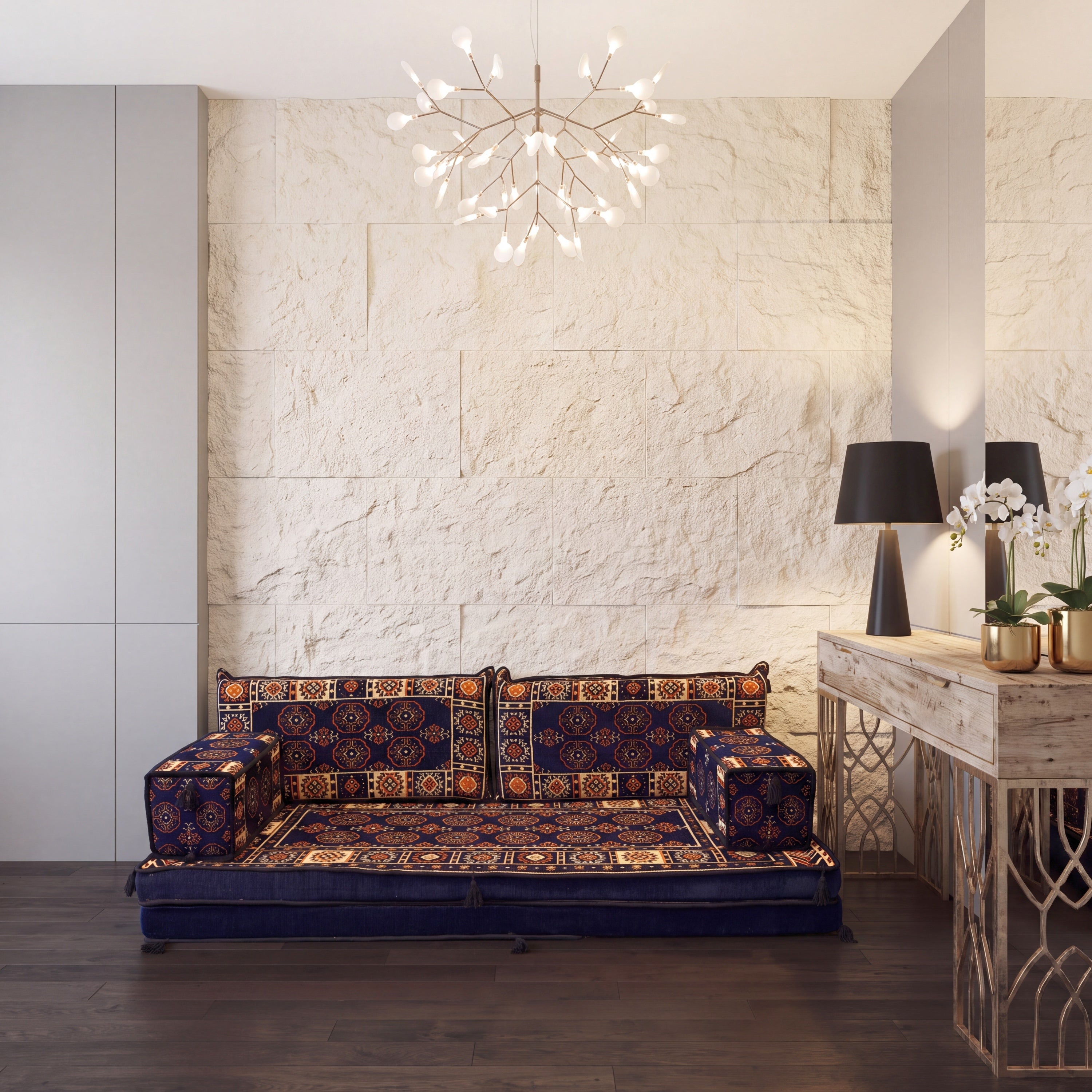 A low, traditional modular floor sofa with a dark navy blue base and bukhara patterned cushions styled in a modern Mediterranean interior.