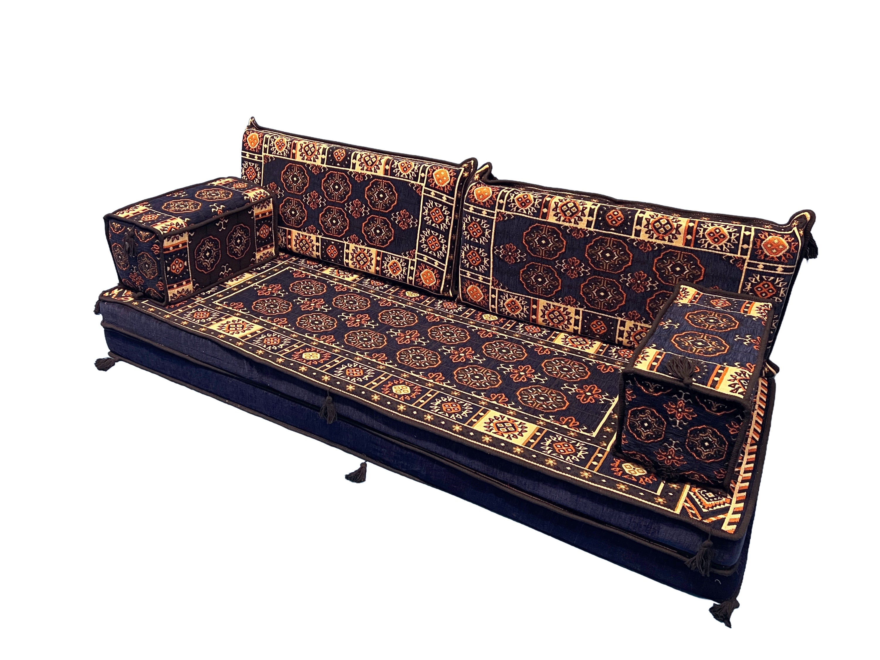 A low-profile modular sofa with thick cushions, upholstered in a dark navy blue fabric featuring intricate geometric and circular patterns in orange, beige, and gold, shown against a plain white background.