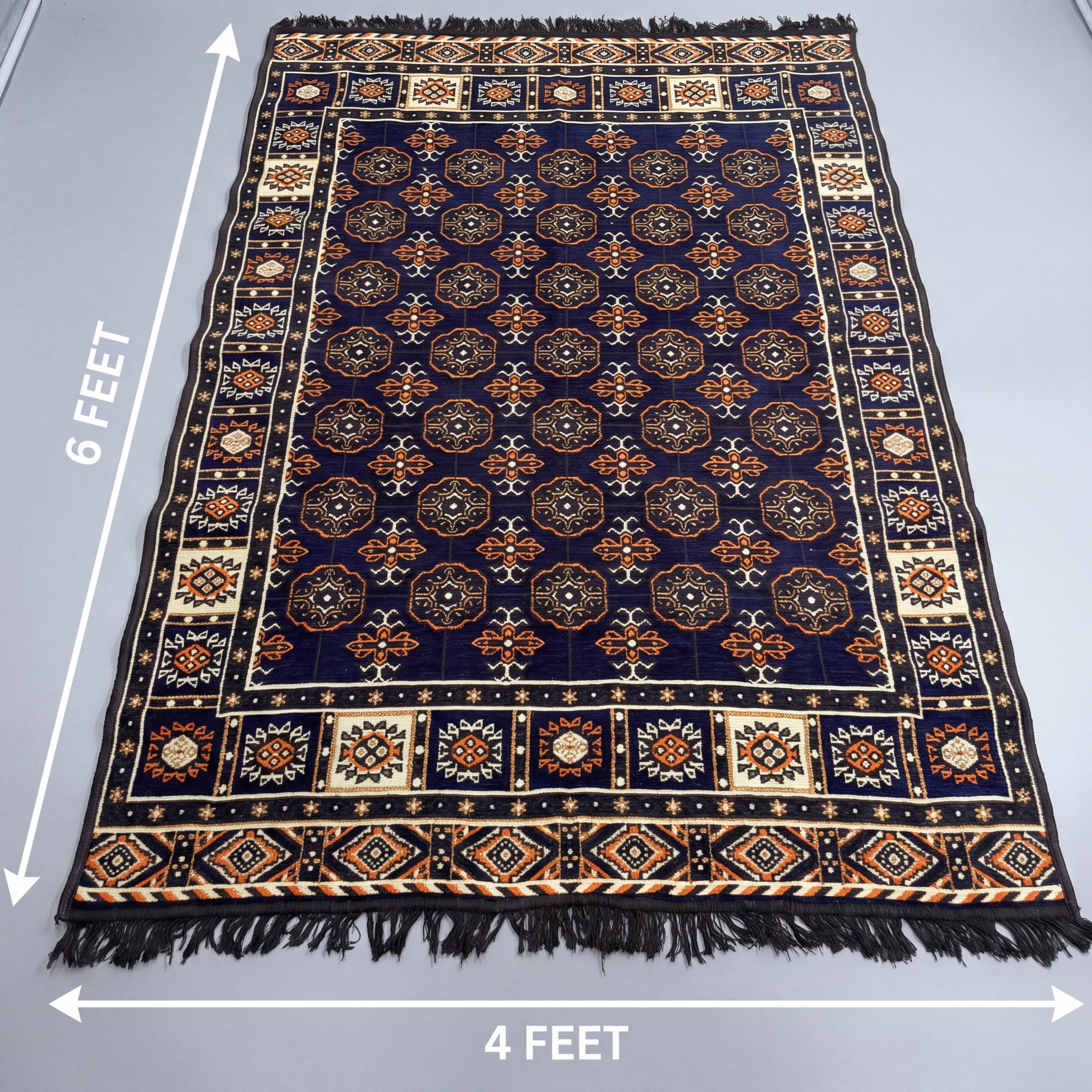 A rectangular bukhara patterned rug laid flat on a light gray surface, with white dimension arrows and text showing 6 feet tall by 4 feet wide. The rug has a dark navy field with repeating circular medallion motifs in beige, orange, and brown, plus a decorative border and fringe on sides.