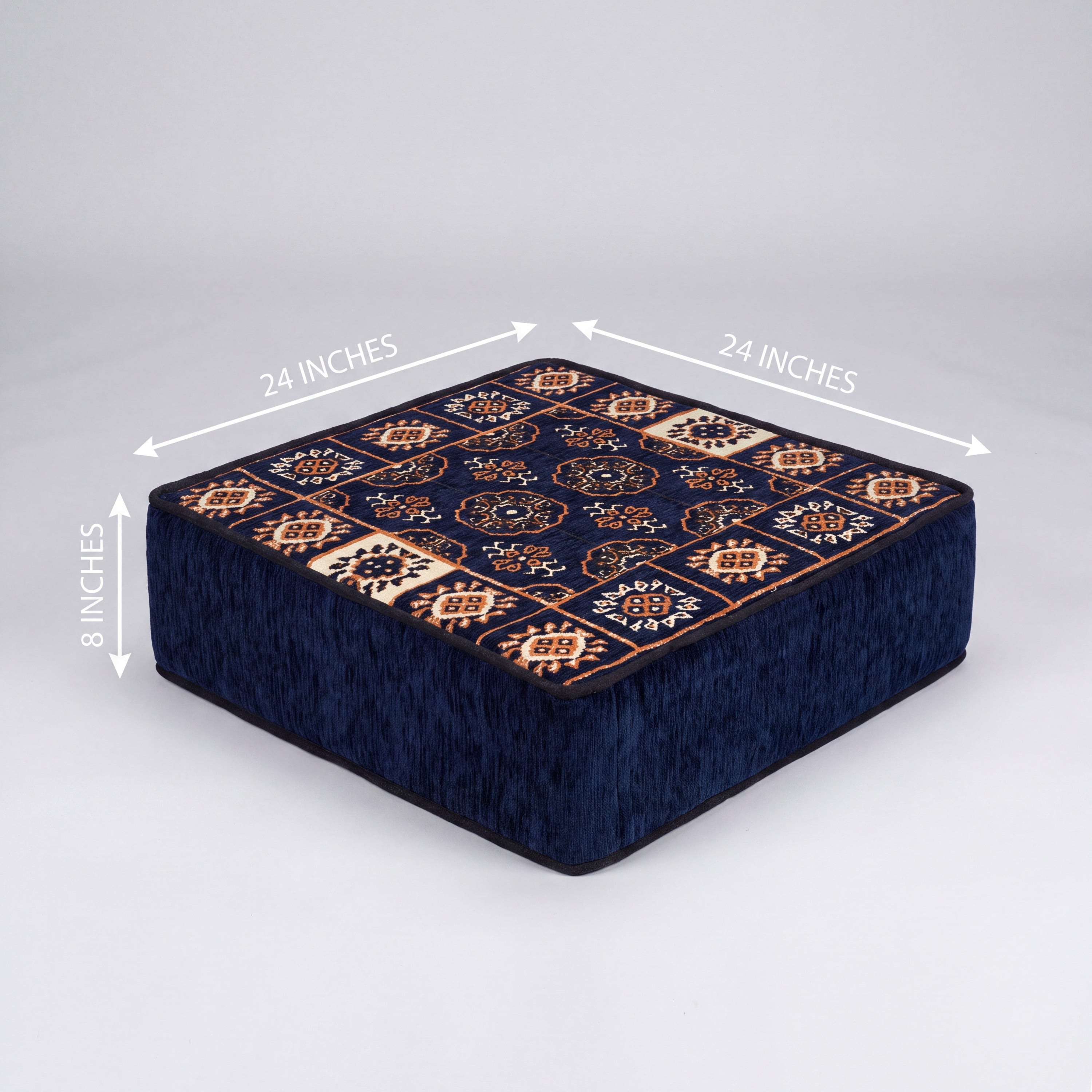 A square ottoman with a dark navy blue base and a patterned top featuring bukhara Turkish motifs. White dimension arrows and text indicate measurements of 24 inches by 24 inches by 8 inches.