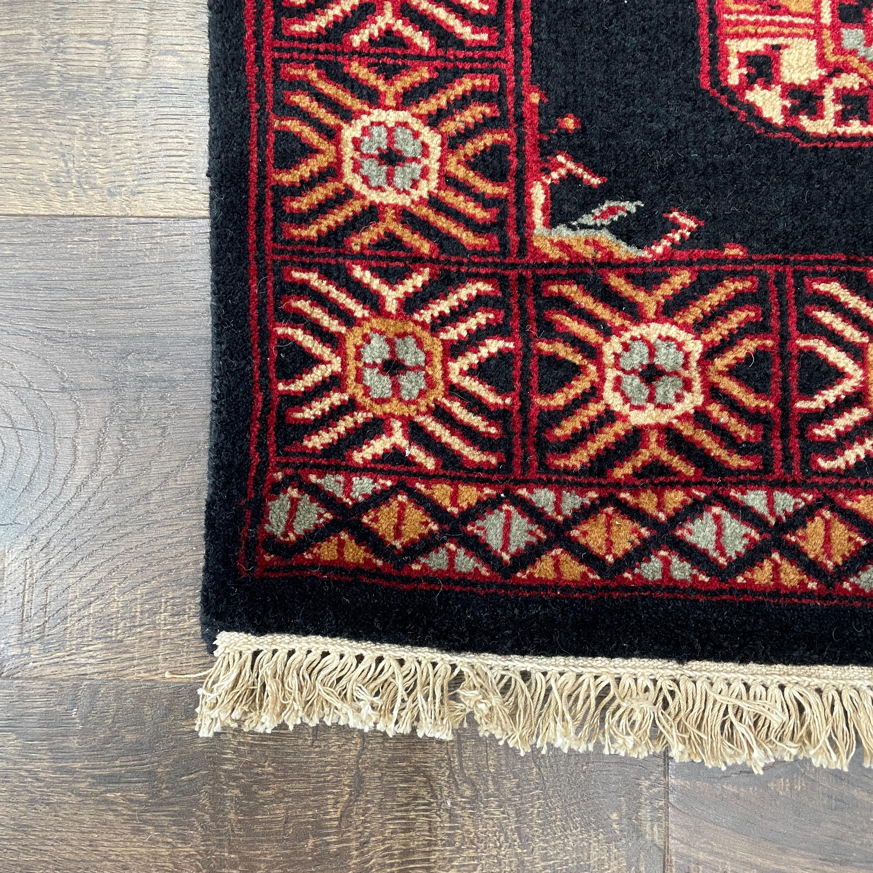 Handmade Turkish Wool Rug: Vintage Black Tribal Design (1'10" x 3')