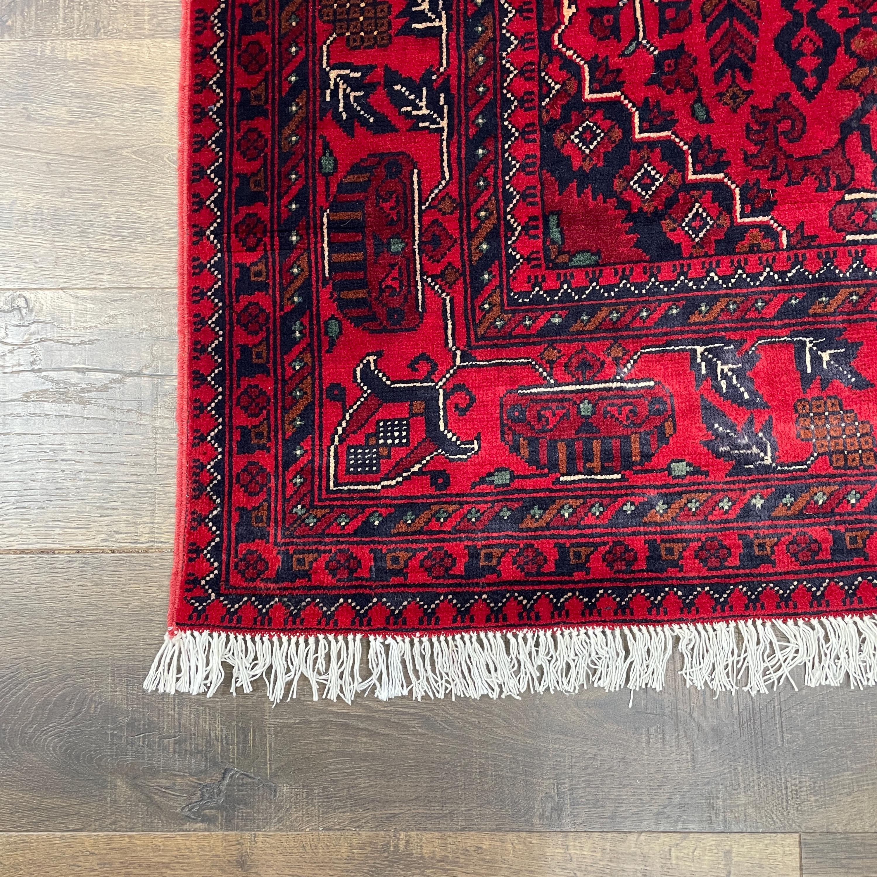 Handmade Red Wool Rug: 5' x 6'9" Turkish Tribal Design