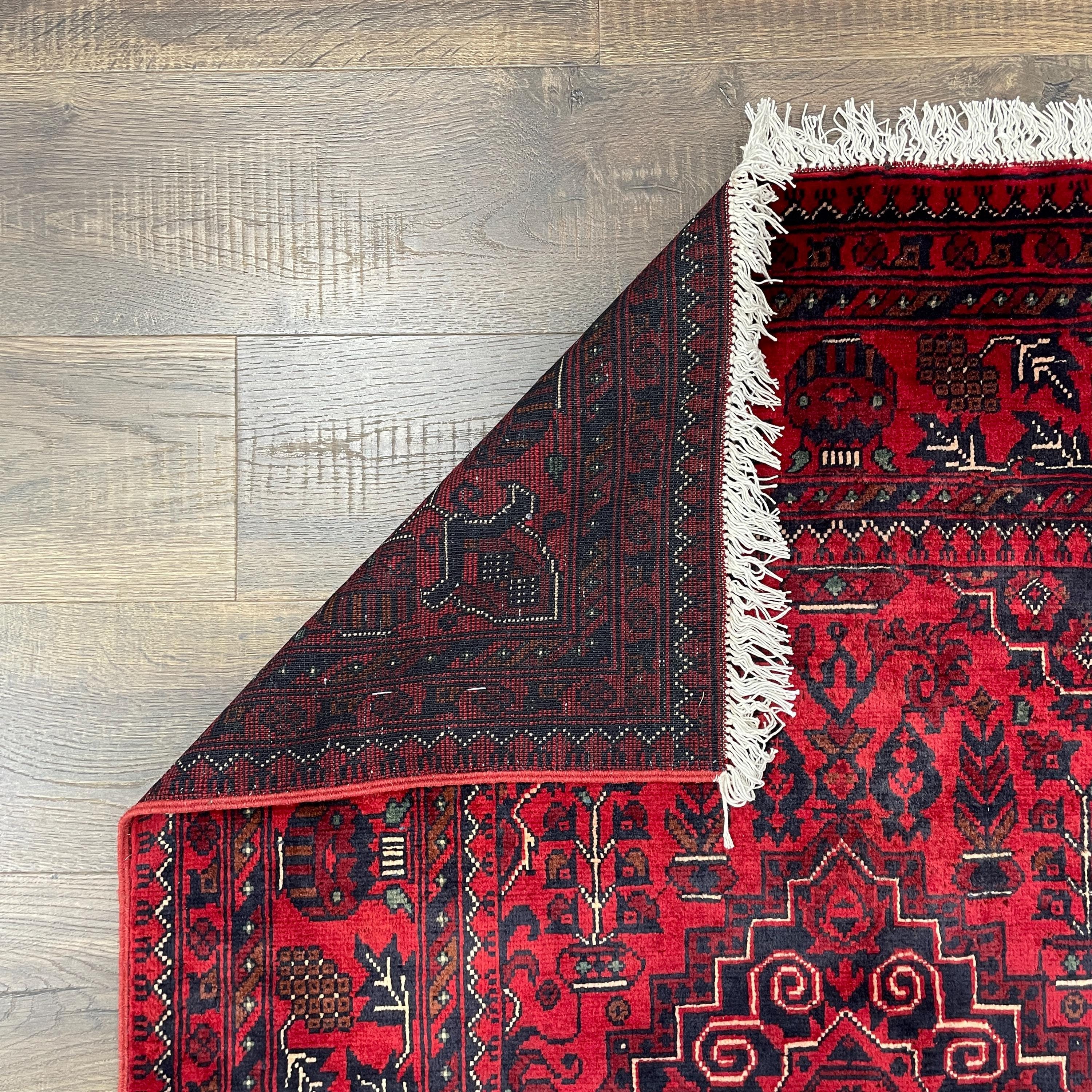 Handmade Red Wool Rug: 5' x 6'9" Turkish Tribal Design